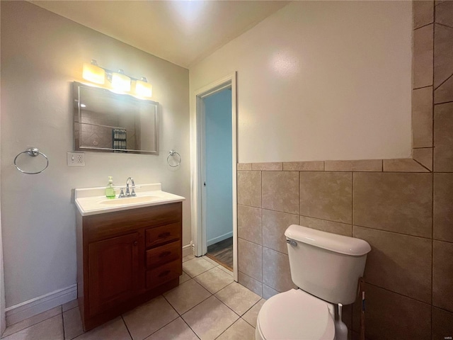 bathroom featuring tile walls, tile patterned flooring, vanity, and toilet