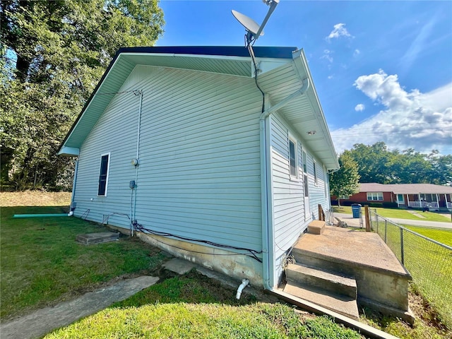 view of property exterior with a yard