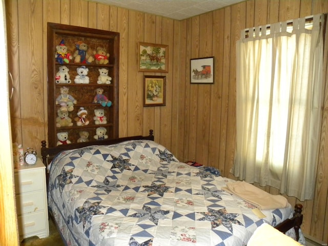 bedroom featuring wooden walls