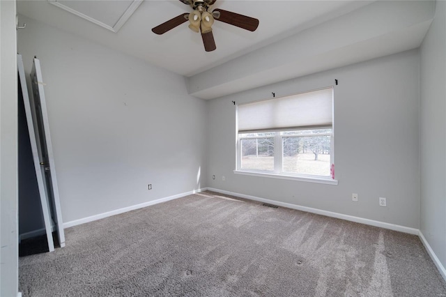 carpeted spare room featuring ceiling fan