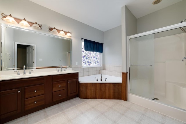 bathroom with vanity and shower with separate bathtub