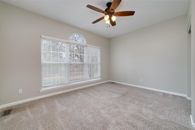 spare room featuring ceiling fan and carpet flooring