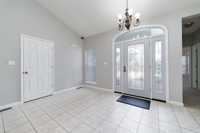 entrance foyer featuring light tile patterned flooring, lofted ceiling, and an inviting chandelier