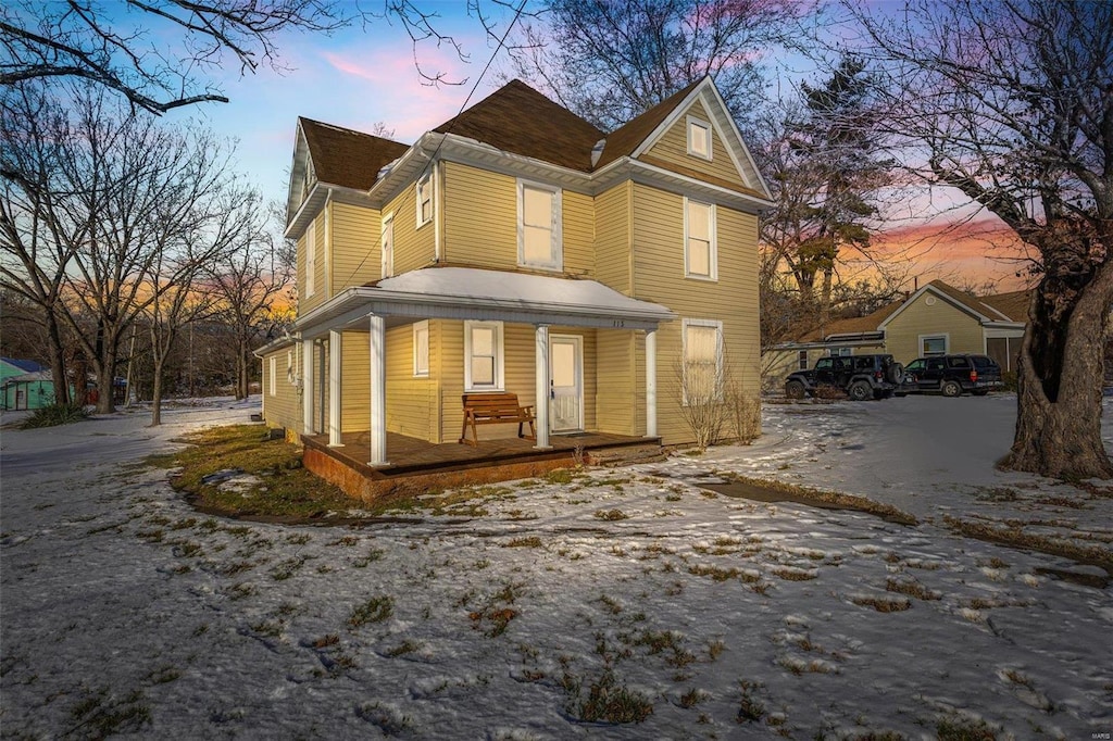 property exterior at dusk with covered porch