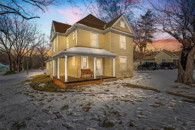 property exterior at dusk with covered porch