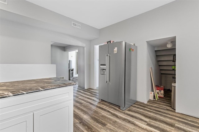 kitchen featuring white cabinetry, dark hardwood / wood-style flooring, dark stone counters, and high quality fridge