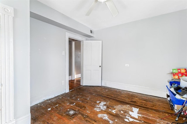 empty room with ceiling fan and dark hardwood / wood-style flooring