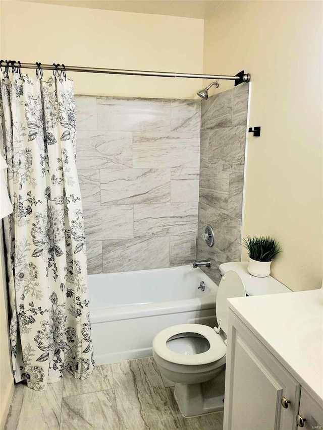 full bathroom featuring vanity, shower / bath combination with curtain, and toilet