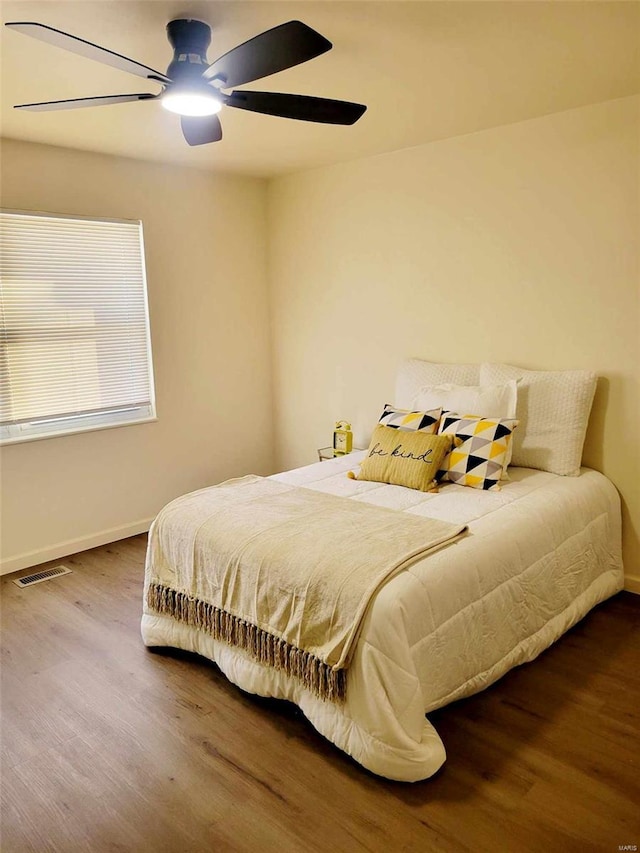 bedroom with ceiling fan and wood-type flooring