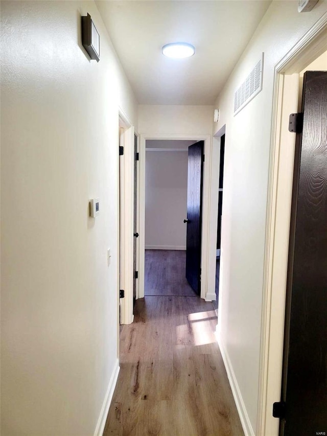 corridor featuring hardwood / wood-style flooring