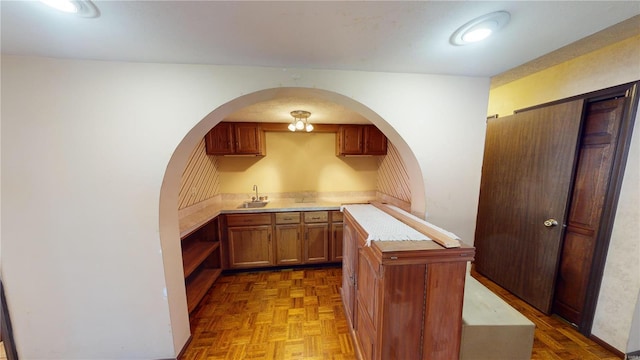 kitchen featuring parquet flooring and sink