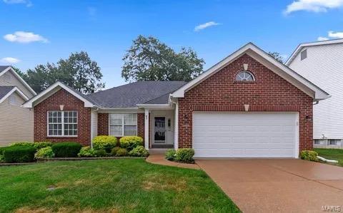 view of front facade with a front lawn and a garage