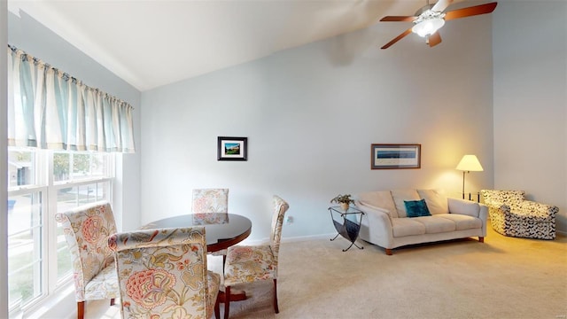 dining room with ceiling fan, vaulted ceiling, and carpet floors