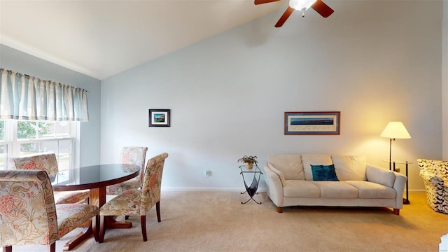 dining area featuring ceiling fan, light carpet, and lofted ceiling