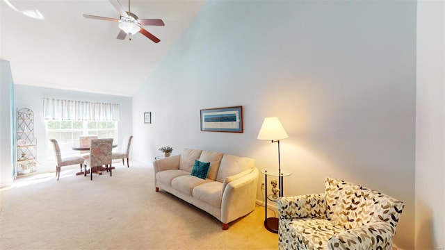 living room featuring high vaulted ceiling, light carpet, and ceiling fan