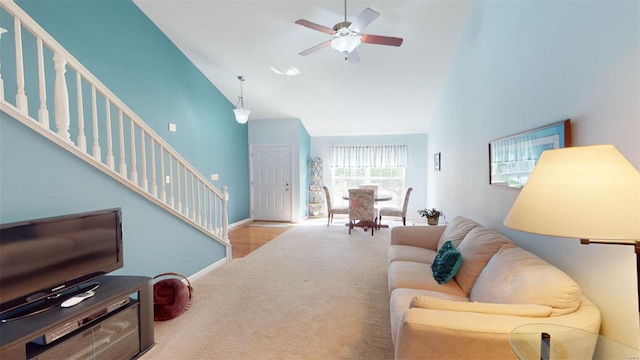 carpeted living room featuring lofted ceiling and ceiling fan