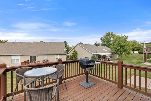 wooden deck with a lawn