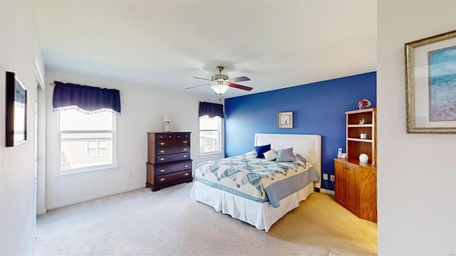 bedroom with ceiling fan and light carpet