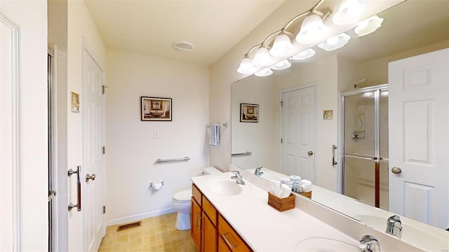 bathroom with an enclosed shower, vanity, and toilet