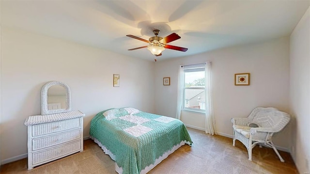 bedroom featuring light colored carpet and ceiling fan