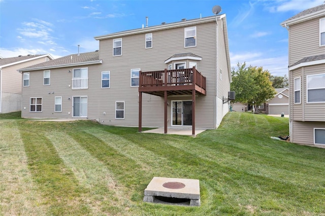 rear view of house featuring a lawn, a patio area, and a wooden deck