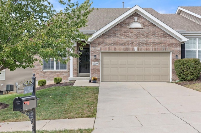 view of front of property with a front yard and a garage