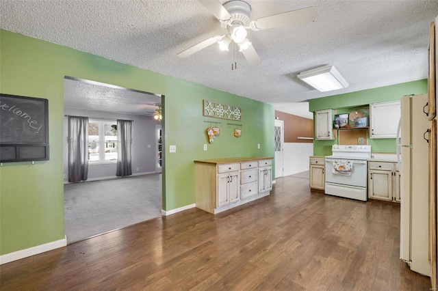 kitchen with dark carpet, white appliances, and a textured ceiling