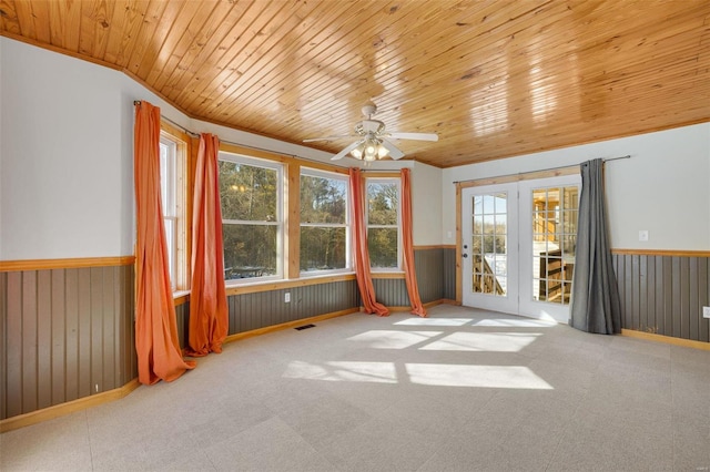 spare room with ceiling fan, french doors, plenty of natural light, and wooden ceiling