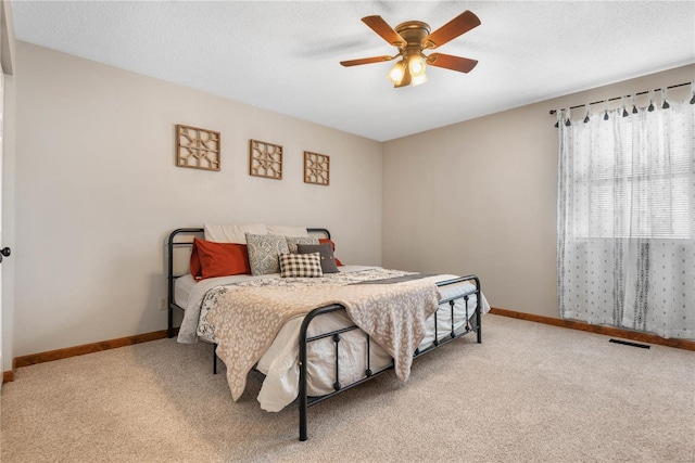 bedroom featuring ceiling fan and light carpet