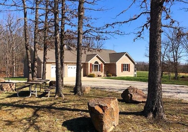 ranch-style home with a front lawn and a garage