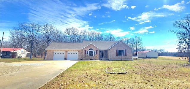 ranch-style home with an attached garage, driveway, a front lawn, and brick siding