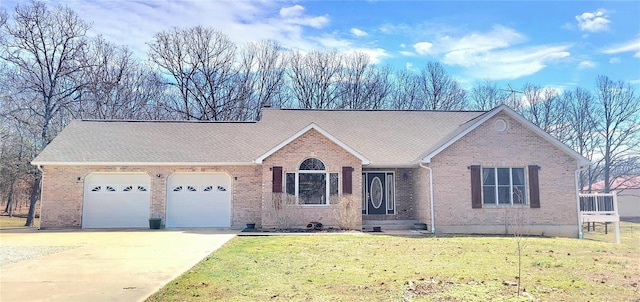 single story home with driveway, a front lawn, an attached garage, and brick siding