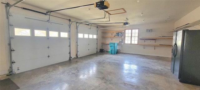 garage featuring black fridge and a garage door opener