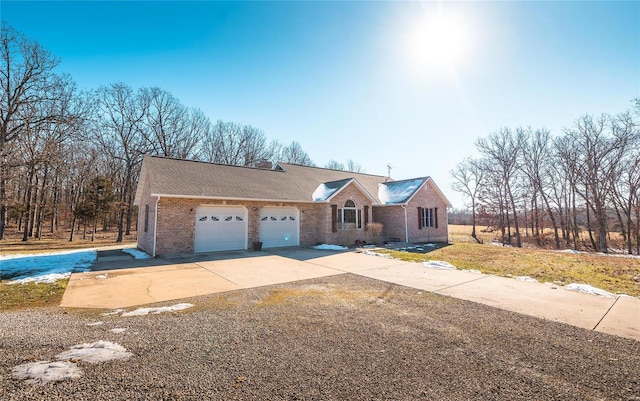 view of front of property with a garage, brick siding, and driveway