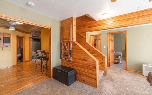 staircase featuring carpet floors and baseboards