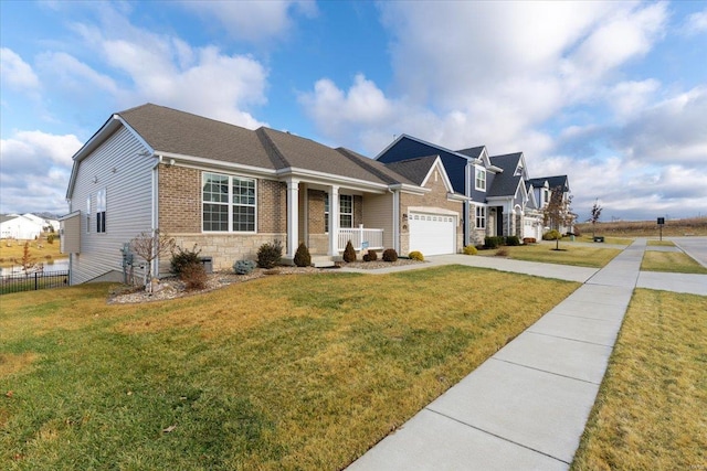 view of front of property with driveway, brick siding, a front lawn, and fence