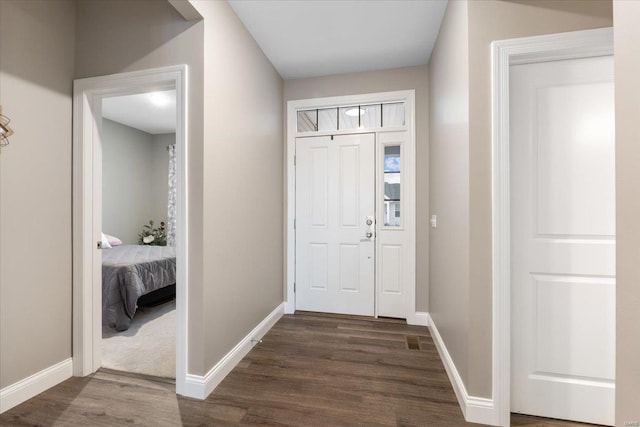 entryway with visible vents, dark wood-style floors, and baseboards