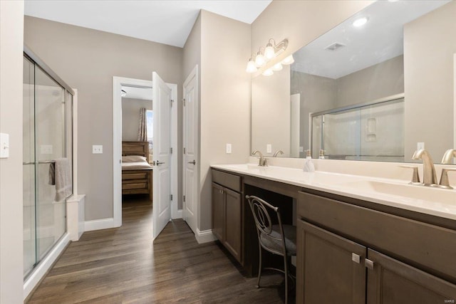 bathroom with ensuite bath, wood finished floors, a stall shower, and a sink