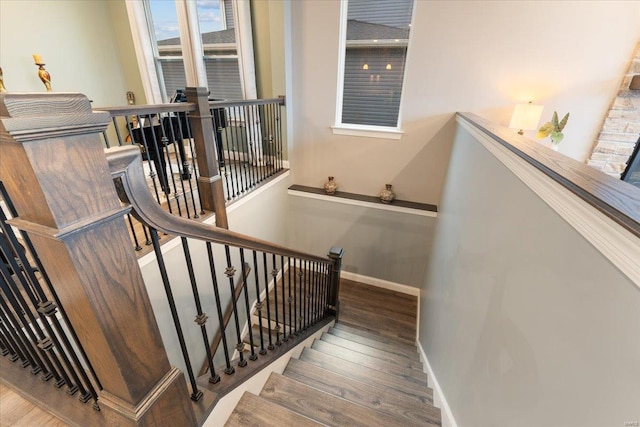 stairs with baseboards and wood finished floors