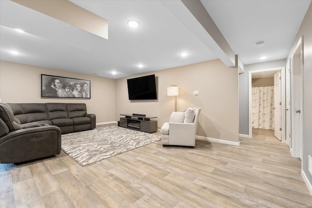 living room featuring beam ceiling, recessed lighting, baseboards, and light wood finished floors