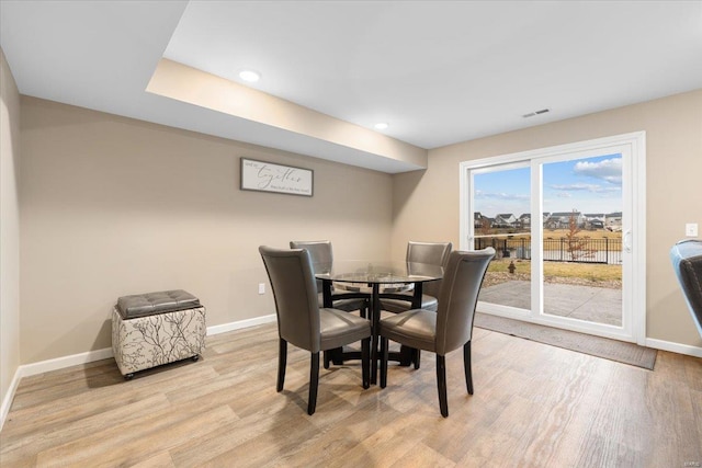 dining room with recessed lighting, baseboards, and light wood-type flooring