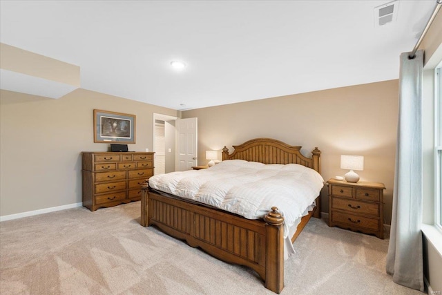 bedroom featuring visible vents, light carpet, and baseboards