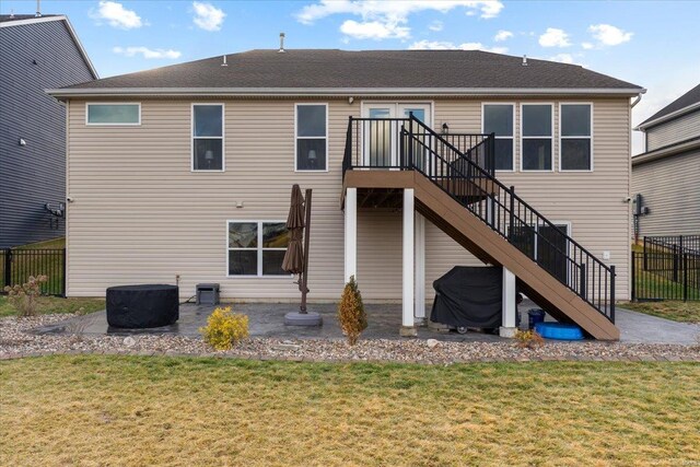 rear view of property with a patio area, stairway, a lawn, and fence