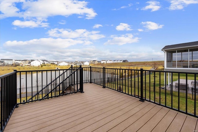 deck with a residential view, a lawn, and a sunroom