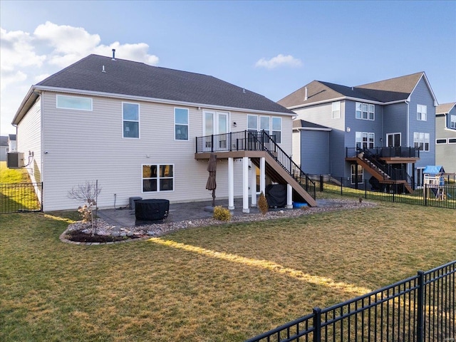 rear view of house featuring a wooden deck, stairs, a yard, a fenced backyard, and a patio area