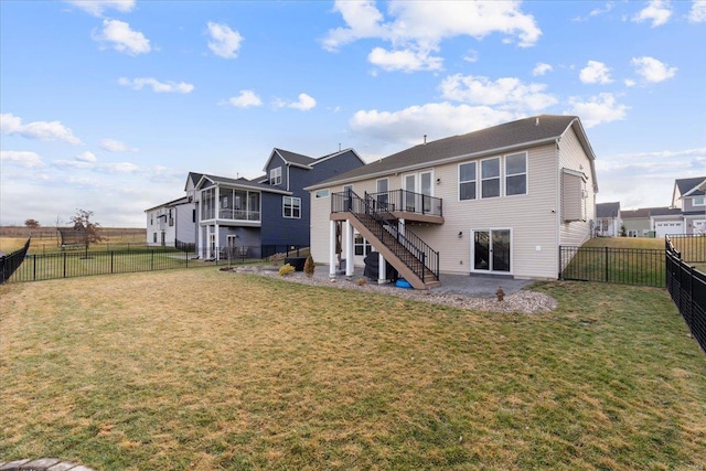 rear view of property with a lawn, stairs, and a fenced backyard