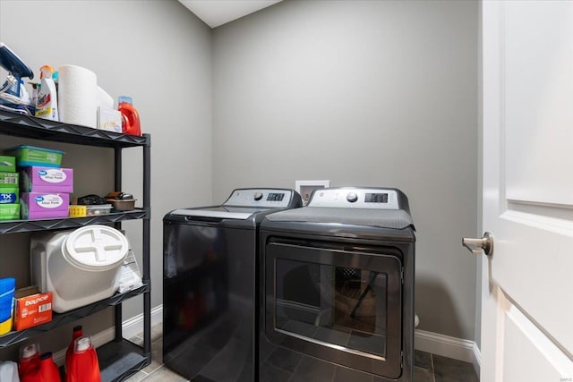 laundry room featuring laundry area, baseboards, and washer and clothes dryer