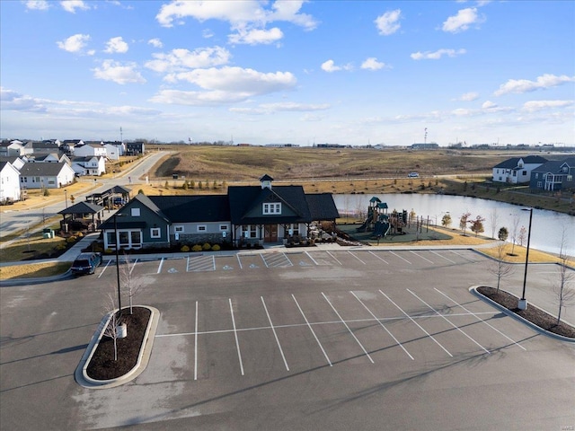 birds eye view of property with a water view and a residential view