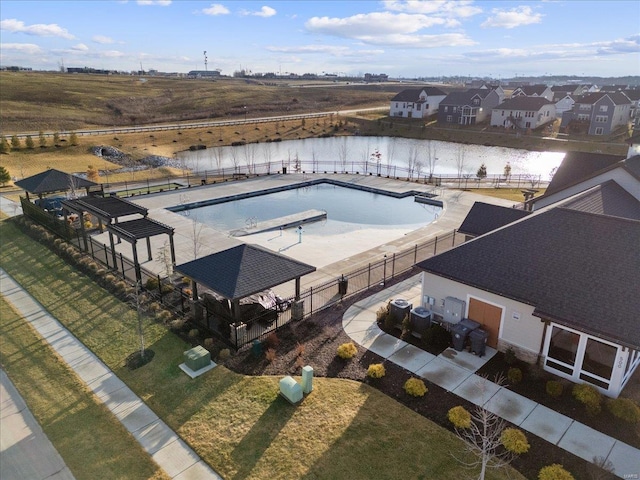 pool with a residential view, a water view, and fence