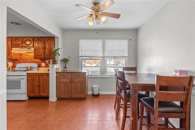 dining space with light tile patterned floors and ceiling fan